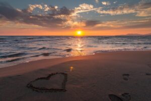 sunset heart in sand